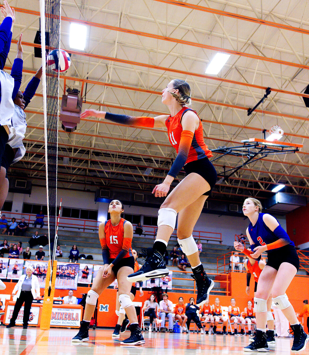 Olivia Hughes sends the ball over the net toward Mt. Vernon. [view more volleyball]